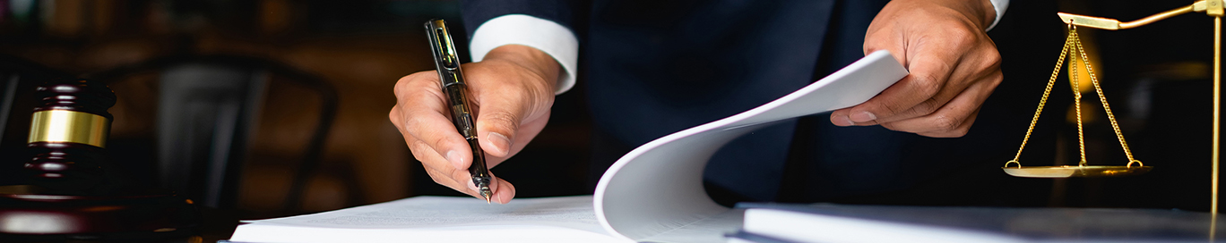 Close up lawyer businessman working or reading lawbook in office workplace for consultant lawyer concept.